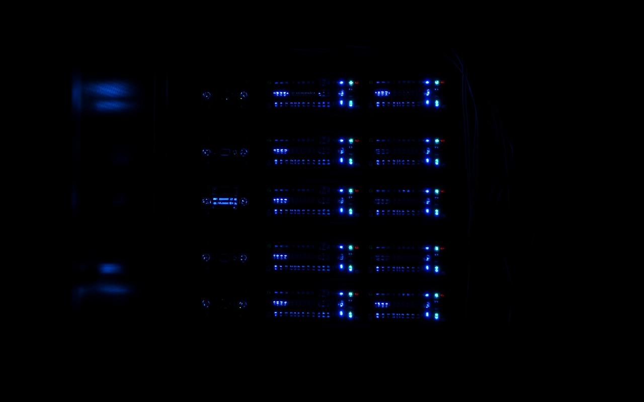 Home server rack with blue status lights in a dark room